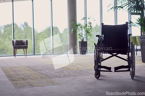 Image of A wheelchair in a modern, spacious office, symbolizing inclusivity and accessibility for business meetings.