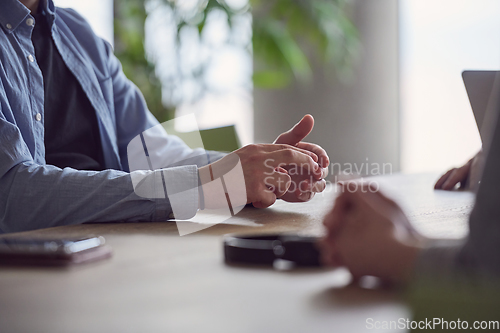 Image of Closeup photo, the hands of businessmen sitting at a business meeting can be seen as they discuss various business ideas and engage in productive collaboration.