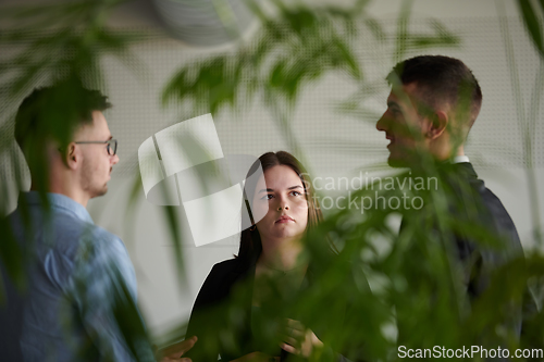 Image of A diverse group of business professionals gathered at a modern office for a productive and inclusive meeting