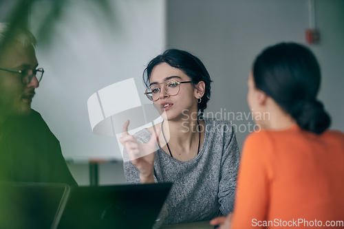 Image of A diverse group of business professionals gathered at a modern office for a productive and inclusive meeting