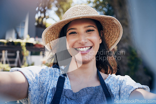 Image of To nurture a garden is to feed the mind. a florist taking a selfie in a nursery at work.