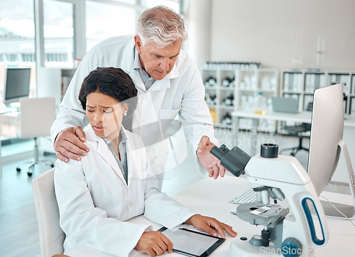 Image of This is so inappropriate. a young scientist looking uncomfortable while being touched on her shoulder by a senior scientist in a lab.