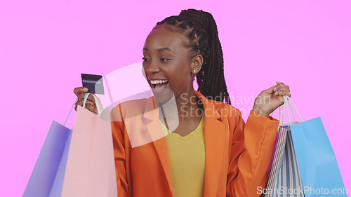 Image of Woman, credit card and shopping bag with wow for fashion payment, e commerce sale and discount in studio. Excited customer or african winner for banking, debit and clothes or gift on pink background