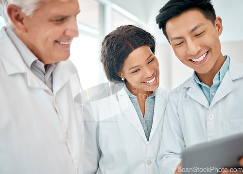 Image of Using technology throughout their experiments. a group of scientists working together on a digital tablet in a lab.