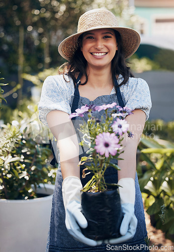 Image of Good health and a sense of well being. a young female florist working at a nursery.