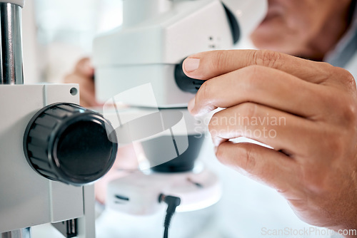 Image of Look closely, theres a lot to see. Closeup shot of an unrecognisable scientist using a microscope in a lab.