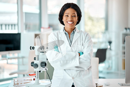 Image of Determined to gain results. Portrait of a young scientist standing with her arms crossed in a lab.