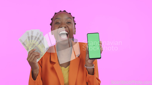 Image of Woman, phone green screen and money for success, bonus or winning of lottery or competition, profit and wow in studio. African winner, portrait and mobile mockup for cash prize on a pink background