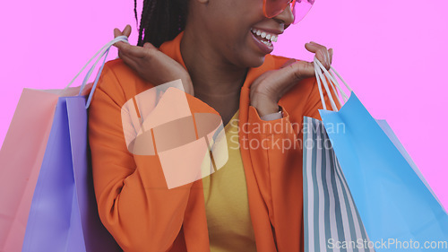 Image of Woman, happy with shopping bag and retail, commerce and fashion, sale or store discount on pink background. Customer with purchase, market and luxury with service, excited about savings in studio
