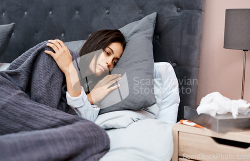 Image of Battling the flu Stay in bed. a young woman recovering from an illness in bed at home.