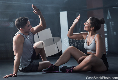 Image of Give it your best and get what youve always wanted. a young man and woman giving each other a high five at the gym.