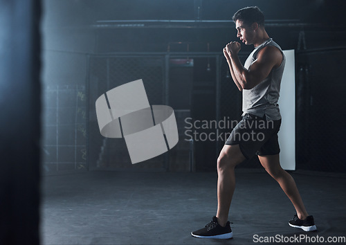 Image of Keep up the pace, keep up the progress. a young man practicing his kickboxing routine at a gym.