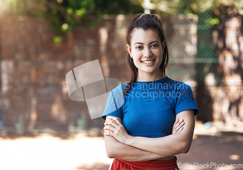 Image of This game gives me confidence. Cropped portrait of an attractive young female athlete standing with her arms folded on the basketball court.