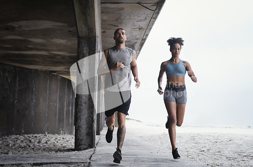 Image of We always run further together. Full lengths shot of a sporty young couple running together outdoors.