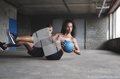 Image of Keep the intensity on a high level. Full length shot of a sport young couple exercising with a ball inside a parking lot.