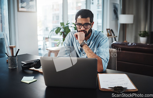 Image of I know just where to go for inspiration. a young man using his laptop while working from home.