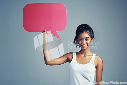 Image of Have your say. Studio portrait of a beautiful young woman holding up a blank signboard against a grey background.