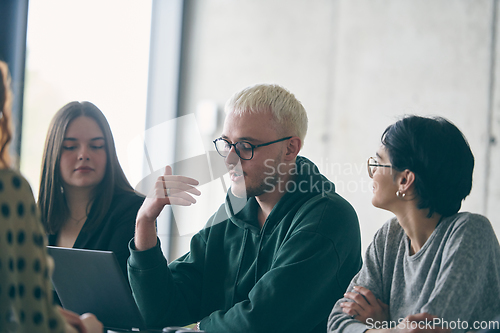 Image of A diverse group of business professionals gathered at a modern office for a productive and inclusive meeting