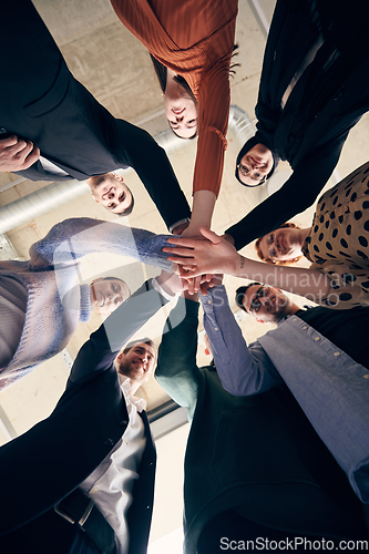 Image of A group of businessmen holding hands together to symbolize unity and strength