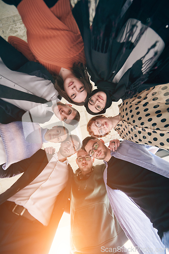 Image of A diverse group of business professionals, embracing each other tightly, symbolizes unity and solidarity