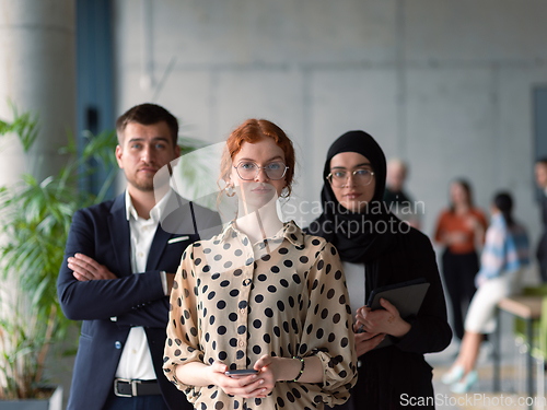 Image of A group of young business entrepreneurs engages in a lively discussion within the office, exemplifying the spirit of teamwork, innovation, and ambition in pursuit of success.