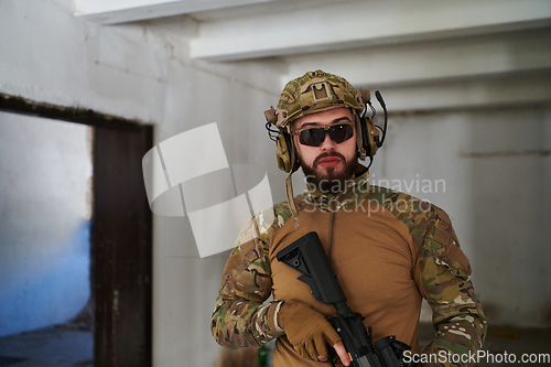 Image of Modern warfare soldier portrait in urban environment