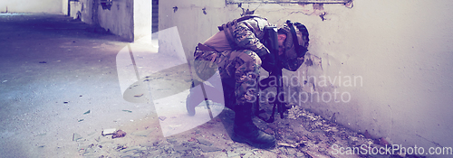 Image of A professional soldier carries out a dangerous military mission in an abandoned building