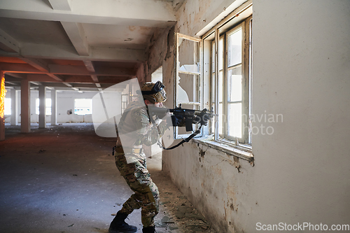 Image of A professional soldier carries out a dangerous military mission in an abandoned building