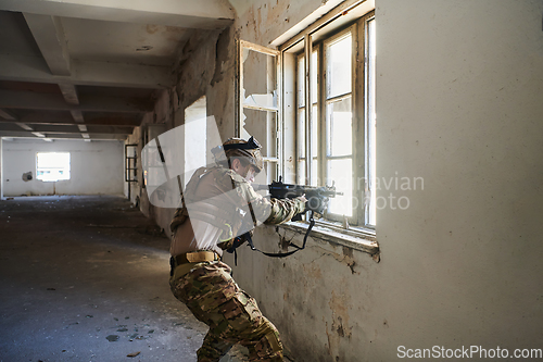 Image of A professional soldier carries out a dangerous military mission in an abandoned building