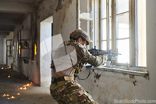 Image of A professional soldier carries out a dangerous military mission in an abandoned building