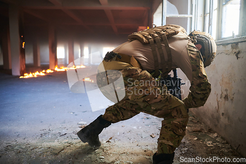 Image of A professional soldier carries out a dangerous military mission in an abandoned building