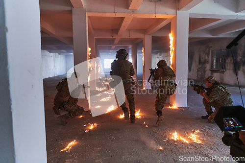 Image of A professional cameraman captures the intense moments as a group of skilled soldiers embarks on a dangerous mission inside an abandoned building, their actions filled with suspense and bravery