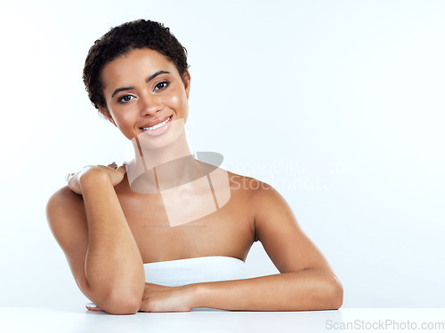 Image of She is happy in her own space. Portrait of an attractive young woman posing against a white background.