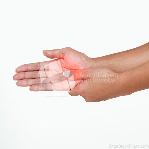 Image of Where did this come from. Studio shot of an unrecognizable woman holding her hand in pain against a white background.