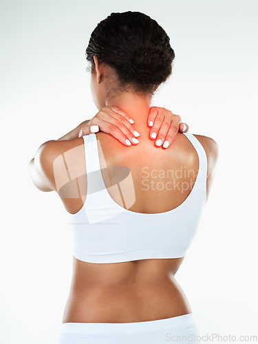 Image of When I work too hard this what happens. Rearview studio shot of an unrecognizable woman holding her neck due to pain while standing against a white background.