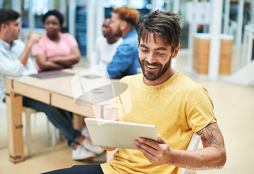 Image of Managing meetings has never been more simpler. a young businessman using a digital tablet during a team meeting in a modern office.