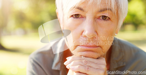 Image of Experience teaches best. Closeup portrait of a senior woman contemplating with her hands clasped outdoors.