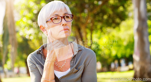 Image of Buried into thought. a senior woman looking thoughtful at the park.