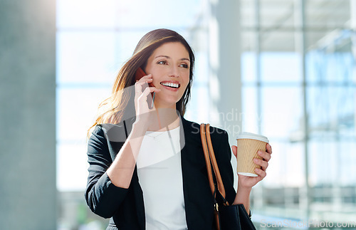 Image of Your jackpot might just be a phone call away. an attractive young businesswoman taking a a phonecall while walking through a modern office.