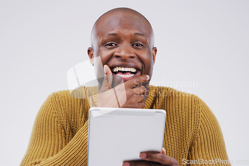 Image of Seems like the internet has something for everyone. Studio shot of a young man looking surprised while using a digital tablet.