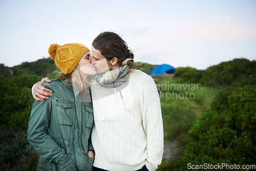 Image of Sharing a kiss in the outdoors. an affectionate young couple kissing outdoors.