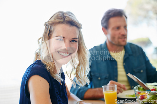 Image of Sharing moments and meals together. Portrait of a young woman enjoying a meal together with her husband at home.