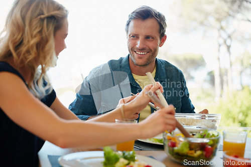 Image of Love, just like food, is best shared together. a couple enjoying a meal together at home.