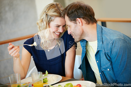 Image of Love makes everything taste ten times better. a couple enjoying a meal together at home.