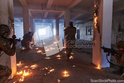 Image of A group of professional soldiers bravely executes a dangerous rescue mission, surrounded by fire in a perilous building.