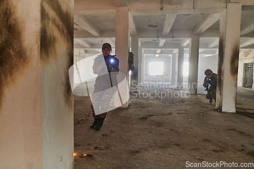 Image of A group of professional soldiers bravely executes a dangerous rescue mission, surrounded by fire in a perilous building.