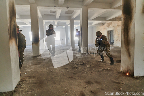 Image of A group of professional soldiers bravely executes a dangerous rescue mission, surrounded by fire in a perilous building.