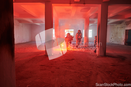 Image of A group of professional soldiers bravely executes a dangerous rescue mission, surrounded by fire in a perilous building.