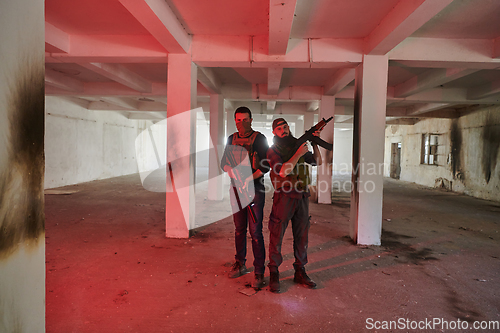 Image of An abandoned building serves as the stronghold for a team of terrorists, fiercely guarding their occupied territory with guns and military equipment