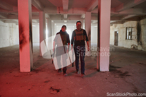 Image of An abandoned building serves as the stronghold for a team of terrorists, fiercely guarding their occupied territory with guns and military equipment